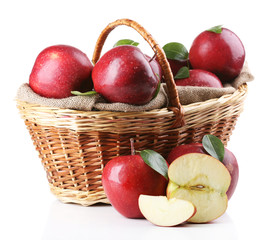 Red apples in wicker basket isolate on white
