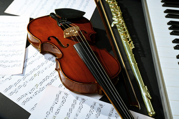 Fototapeta premium Musical instruments with music notes on dark background