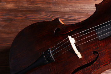 Vintage cello on wooden background