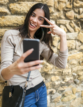 Young woman taking a selfie with her smartphone