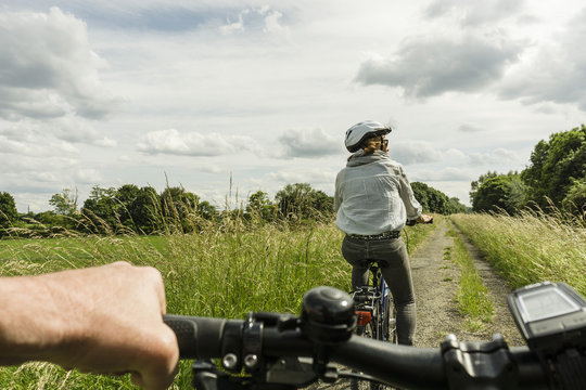 Couple riding bicycle at countryside