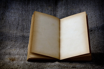Stock Photo:.old book open blank pages, empty yellow paper on da