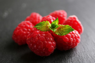 Fresh red raspberries on wooden background