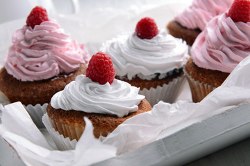 Delicious cupcakes with berries on table close up