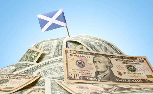 Flag of Scotland sticking in a pile of american dollars.(series)
