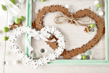 Puzzle made hearts shape on light background