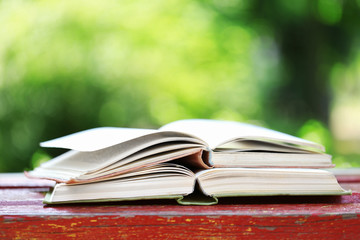 Stack of books outdoors, on blurred background