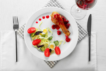 Tasty dinner served with wine on table close up