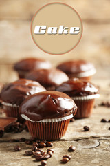Tasty homemade chocolate muffins on wooden table