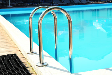 Hotel swimming pool with sunny reflections