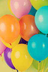 Colorful balloons on green background