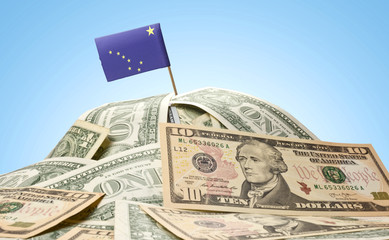 Flag of Alaska sticking in a pile of american dollars.(series)