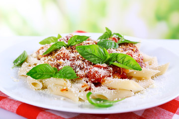Pasta with tomato sauce on bright background