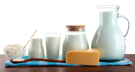Dairy products on wooden table on white background