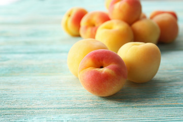 Ripe apricots on wooden table close up