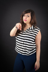 Fototapeta premium Beautiful woman doing different expressions in different sets of clothes: pointing