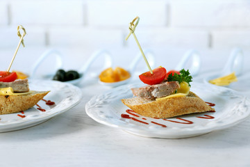 Tasty canapes on wooden table, close up