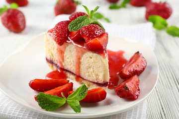 Delicious cheesecake with berries on table close up