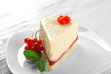 Delicious cheesecake with berries on table close up