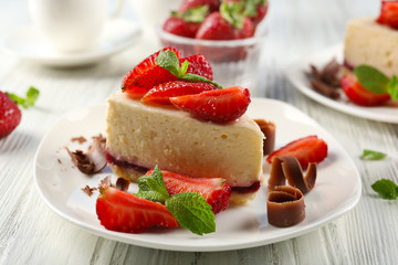 Delicious cheesecake with berries on table close up