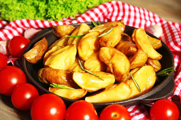 Baked potato wedges on checkered napkin, closeup