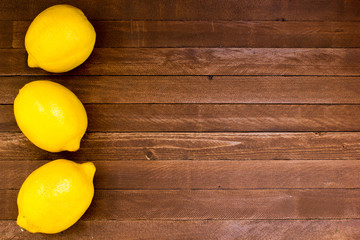 Lemons on wooden background, copy space