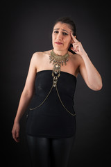 Fototapeta premium Beautiful woman doing different expressions in different sets of clothes: headache