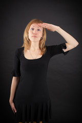 Fototapeta premium beautiful woman doing different expressions in different sets of clothes: at attention