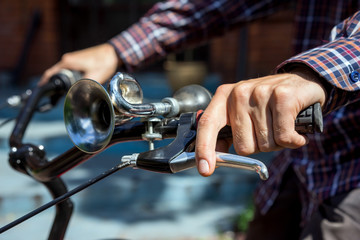 Man on bicycle presses on brake