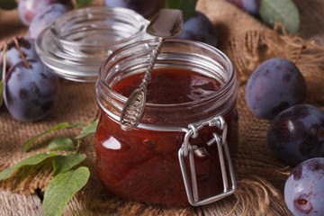 Fresh homemade plum confiture in a glass jar close-up. horizontal
