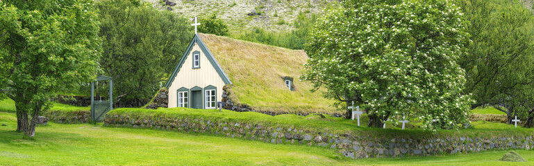 Fototapeta na wymiar Old christian church with grass on the roof in Iceland