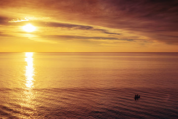 Boat with fishermen at sunset