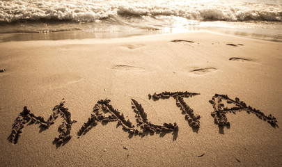 Text Malta on the beach