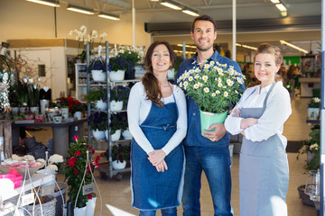 Man Holding Potted Plant White Standing By Salesgirls