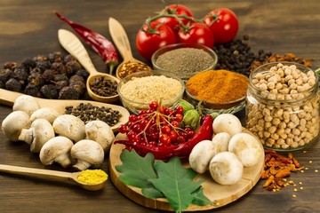  Wooden table with colorful spices, herbs and vegetables.  Wooden table with colorful spices. Asian cuisine