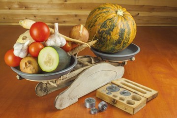 Growing vegetables in the organic farm. Vegetables grown in a small home garden. Old metal weight...