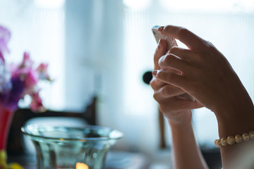 Young woman holding phone in her hands