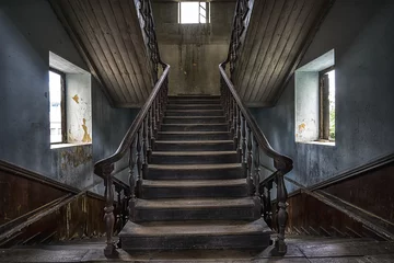 Acrylic prints Old left buildings Wooden staircase in an abandoned house
