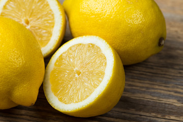 Fresh and juicy lemons on wooden table