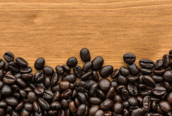 background of brown coffee beans on wood board