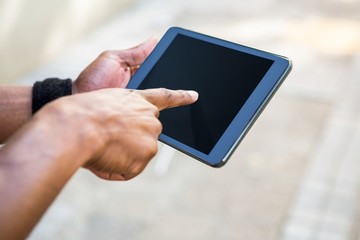 Athletic man using tablet computer