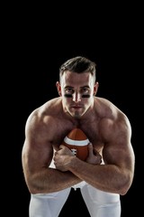 Fototapeta premium Shirtless American football player with ball