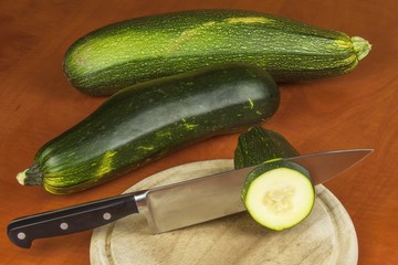 Growing vegetables in the organic farm. Vegetables grown in a small home garden. Old metal weight on homemade food. Background with vegetables. Promotion of healthy diets, diet food preparation.
