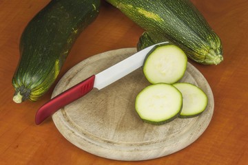 Growing vegetables in the organic farm. Vegetables grown in a small home garden. Old metal weight on homemade food. Background with vegetables. Promotion of healthy diets, diet food preparation.
