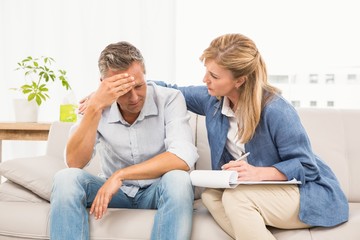 Concerned therapist comforting male patient