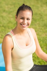Fototapeta premium Smiling fit woman looking at camera