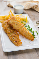 Fish and chips. Fried fish fillet with french fries wrapped by p