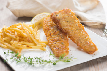 Fish and chips. Fried fish fillet with french fries wrapped by p