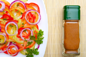 vegetable salad and bottle of spices