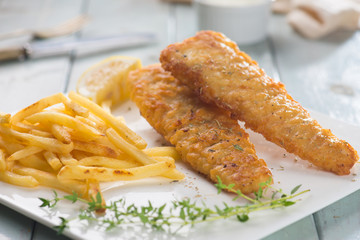 Fish and chips. Fried fish fillet with french fries wrapped by p